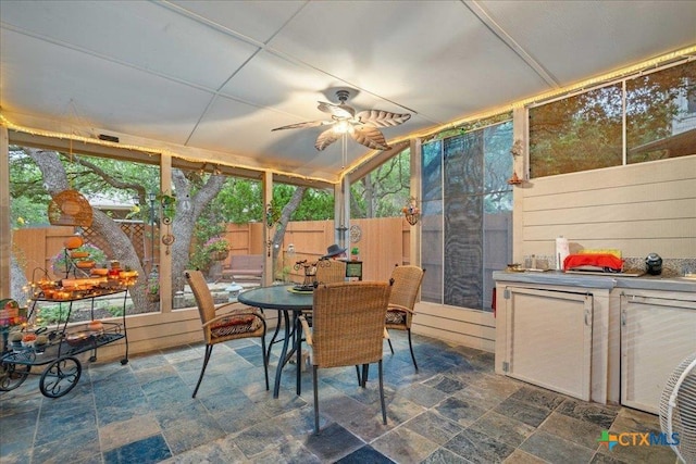 1800 Bluffwood Pl, Round Rock, TX 78665 - sunroom / solarium with outdoor dining area, a ceiling fan, and stone finish floors