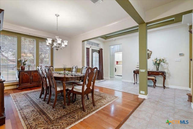 1800 Bluffwood Pl, Round Rock, TX 78665 - dining area with a chandelier, washer / clothes dryer, ornamental molding, and light tile patterned floors