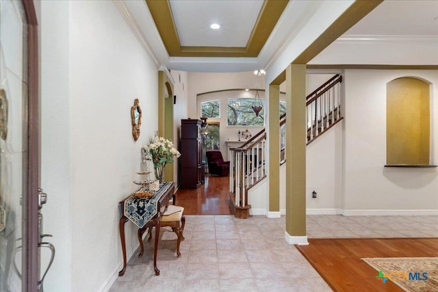 1800 Bluffwood Pl, Round Rock, TX 78665 - foyer featuring arched walkways, ornamental molding, stairway, light wood-style flooring, and a tray ceiling