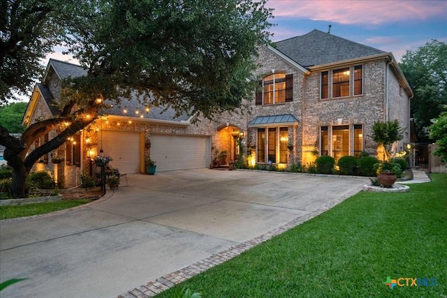 1800 Bluffwood Pl, Round Rock, TX 78665 - view of front of property with concrete driveway, a front lawn, brick siding, and a garage