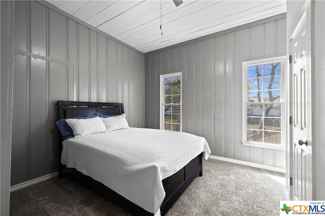 bedroom featuring wood walls, ceiling fan, wood ceiling, and carpet