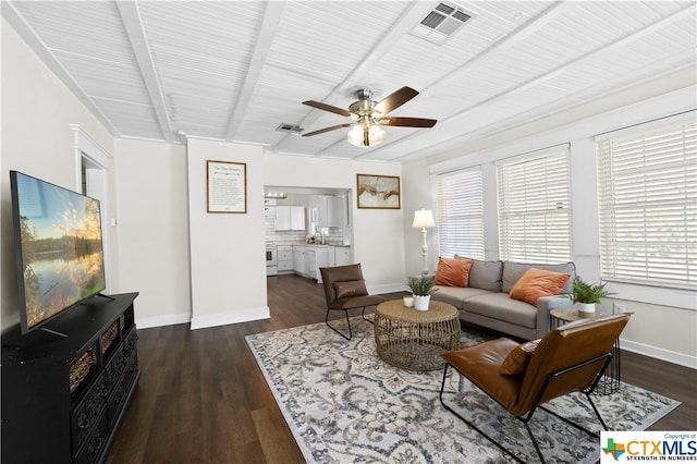 living room with dark hardwood / wood-style flooring, beamed ceiling, sink, and ceiling fan