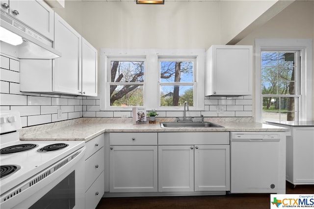 kitchen with white cabinetry, tasteful backsplash, sink, and white appliances