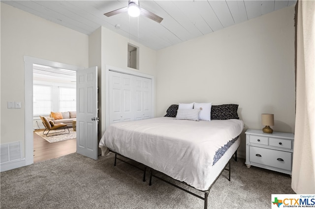 bedroom with hardwood / wood-style floors, wooden ceiling, ceiling fan, and a closet