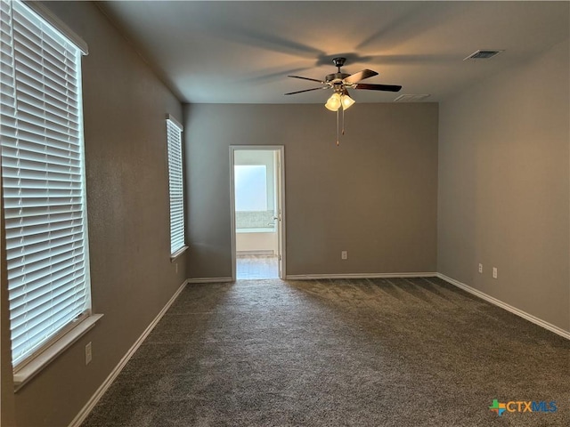 empty room with a ceiling fan, baseboards, visible vents, and carpet flooring