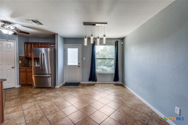 7631 Sterling Mnr, Converse, TX 78109 - unfurnished dining area with a textured wall, a textured ceiling, ceiling fan, and light tile patterned flooring