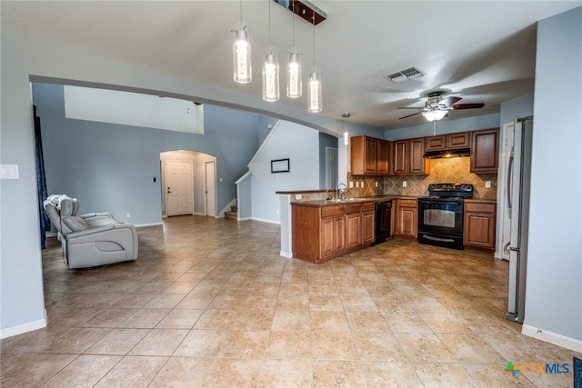 7631 Sterling Mnr, Converse, TX 78109 - kitchen featuring black appliances, arched walkways, a peninsula, brown cabinets, and open floor plan