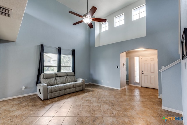7631 Sterling Mnr, Converse, TX 78109 - living room with arched walkways, ceiling fan, and a towering ceiling