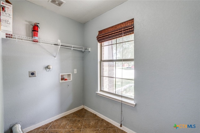 7631 Sterling Mnr, Converse, TX 78109 - washroom featuring hookup for a washing machine, electric dryer hookup, and dark tile patterned flooring