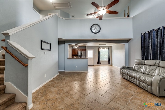 7631 Sterling Mnr, Converse, TX 78109 - living area featuring ceiling fan, a high ceiling, and stairway