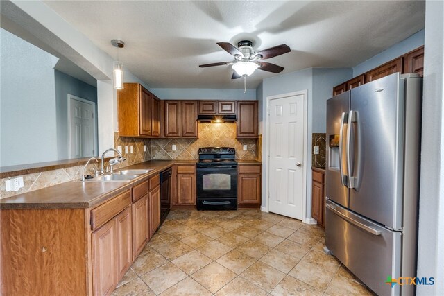 7631 Sterling Mnr, Converse, TX 78109 - kitchen with black appliances, under cabinet range hood, a ceiling fan, backsplash, and brown cabinetry