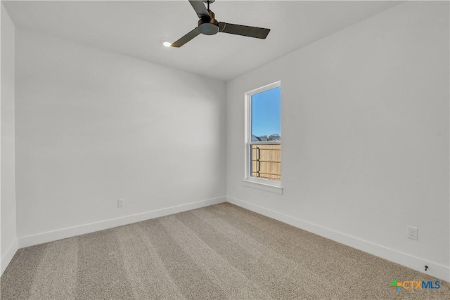 carpeted spare room featuring ceiling fan