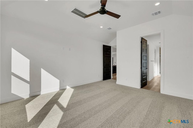 carpeted empty room featuring lofted ceiling and ceiling fan