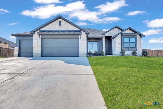 ranch-style house with a garage and a front lawn