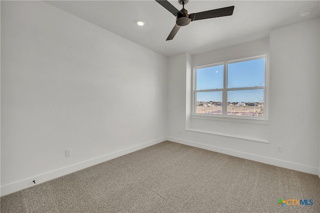 carpeted empty room featuring ceiling fan