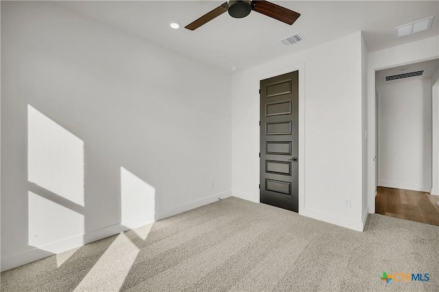 unfurnished room featuring light carpet and ceiling fan