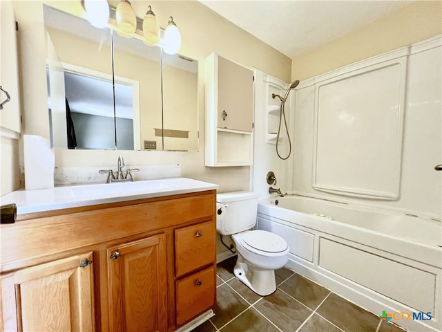 105 Kensington Dr, Victoria, TX 77901 - bathroom featuring toilet, vanity, tile patterned flooring, and washtub / shower combination