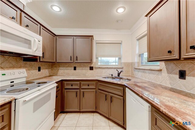 4700 Aurora Cir, Killeen, TX 76542 - kitchen with white appliances, a sink, ornamental molding, decorative backsplash, and light tile patterned floors