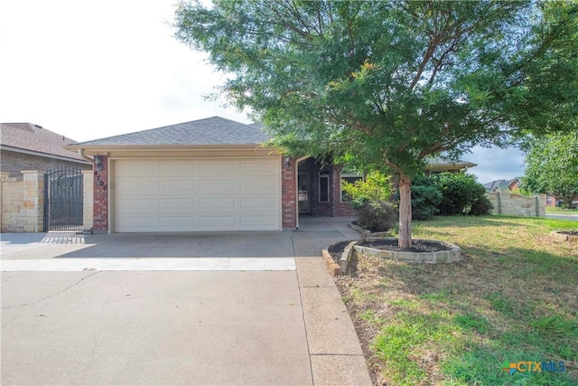 4700 Aurora Cir, Killeen, TX 76542 - single story home with concrete driveway, a garage, brick siding, a front yard, and a gate