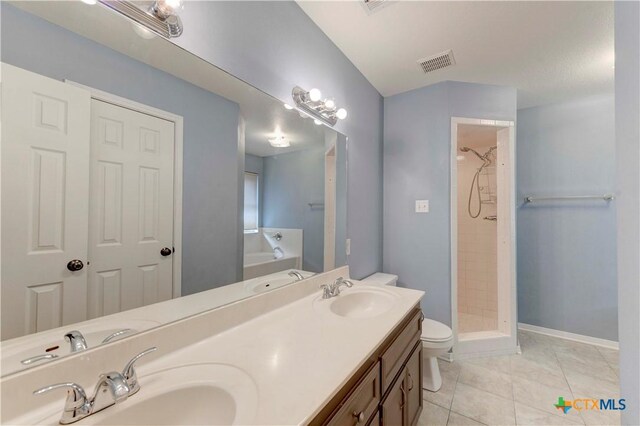 4700 Aurora Cir, Killeen, TX 76542 - bathroom featuring double vanity, toilet, a garden tub, a shower stall, and tile patterned flooring
