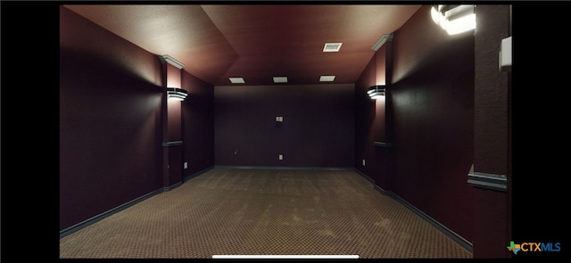 cinema with visible vents, light carpet, and baseboards