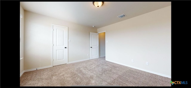 unfurnished bedroom with visible vents, carpet floors, and baseboards