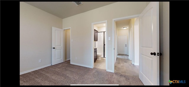 unfurnished bedroom with connected bathroom, baseboards, visible vents, and light carpet