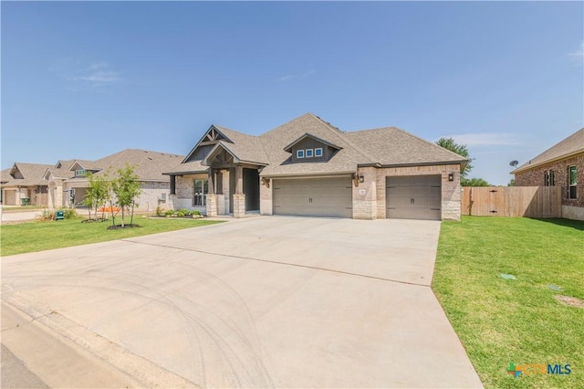 711 Saddlehorn Dr, Temple, TX 76502 - craftsman-style home with a garage, concrete driveway, stone siding, roof with shingles, and brick siding