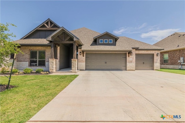 711 Saddlehorn Dr, Temple, TX 76502 - craftsman house featuring concrete driveway, a garage, a front yard, a shingled roof, and brick siding