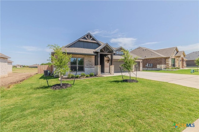 711 Saddlehorn Dr, Temple, TX 76502 - craftsman inspired home featuring concrete driveway, an attached garage, a front lawn, board and batten siding, and brick siding