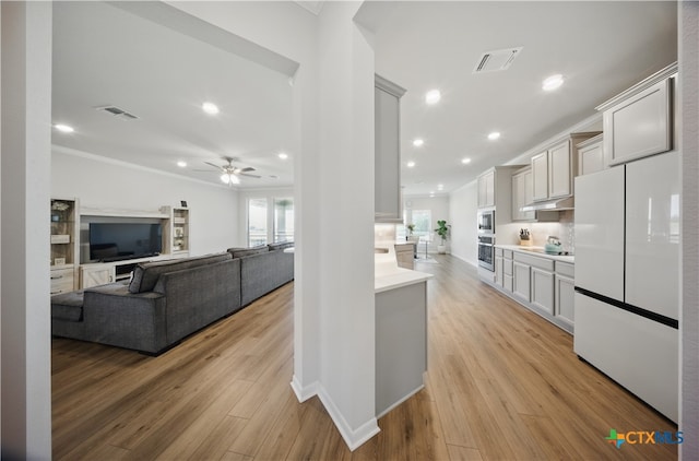 711 Saddlehorn Dr, Temple, TX 76502 - kitchen featuring freestanding refrigerator, crown molding, light countertops, ceiling fan, and light wood finished floors
