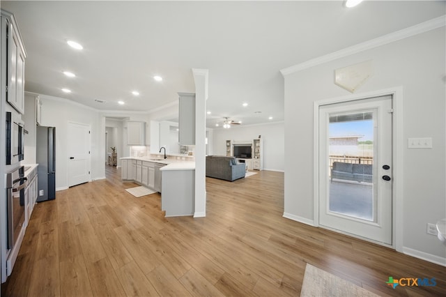 711 Saddlehorn Dr, Temple, TX 76502 - kitchen featuring a sink, light countertops, open floor plan, stainless steel appliances, and ceiling fan