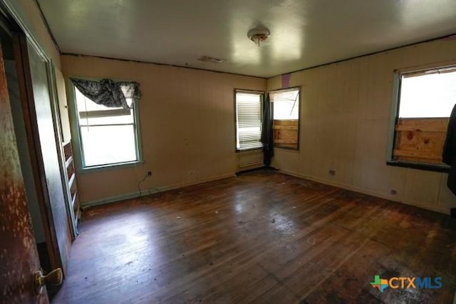 626 E Wallace St, Gonzales, TX 78629 - empty room featuring plenty of natural light and dark wood finished floors
