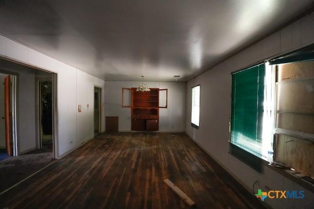626 E Wallace St, Gonzales, TX 78629 - unfurnished living room featuring wood-type flooring and a chandelier