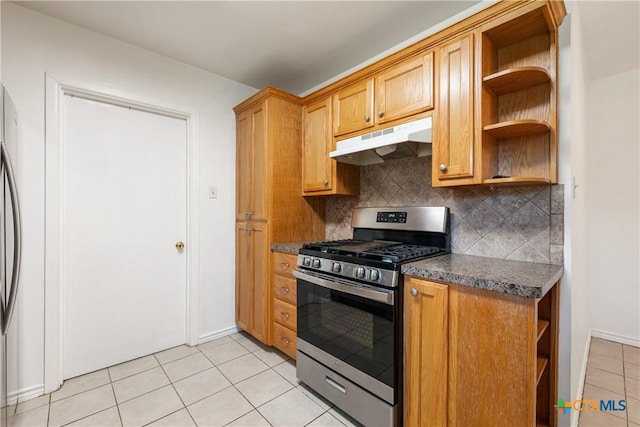 kitchen featuring dark countertops, under cabinet range hood, open shelves, and gas range