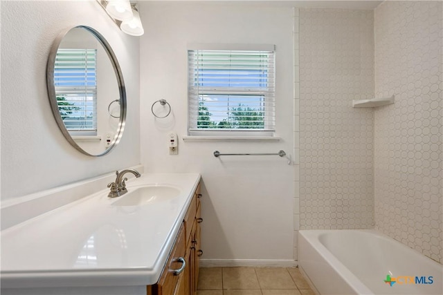 full bathroom with shower / tub combination, tile patterned flooring, vanity, and baseboards