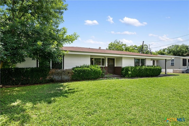 ranch-style home with a carport and a front lawn