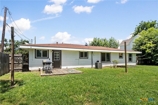 rear view of house with a yard, central AC, fence, and a wooden deck