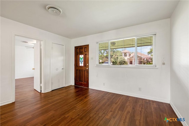 foyer entrance featuring dark wood-type flooring and baseboards