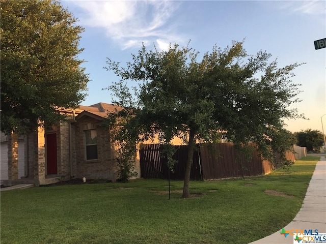 view of yard at dusk