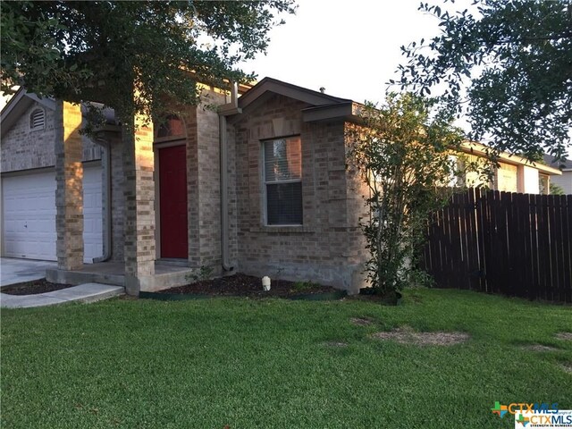 view of property exterior featuring a garage and a yard