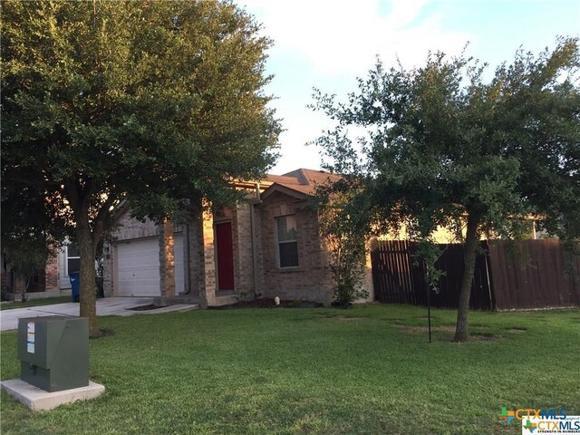 view of front of property with a garage and a front yard