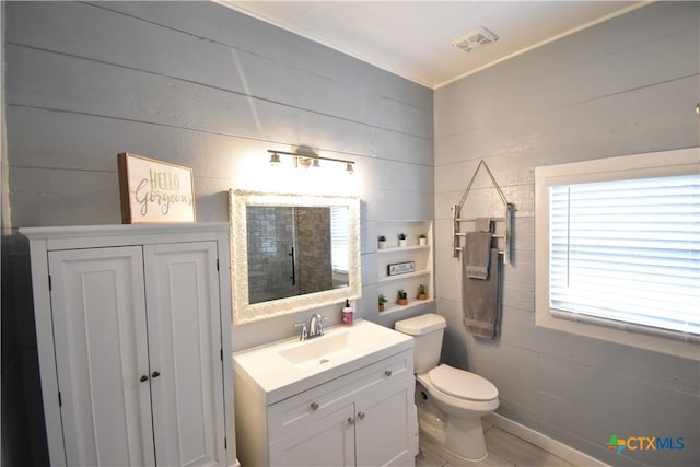 bathroom with visible vents, toilet, and vanity