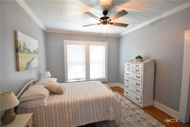 bedroom with light wood-style flooring, crown molding, baseboards, and ceiling fan