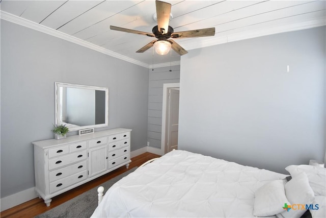 bedroom with dark wood finished floors, ceiling fan, baseboards, and ornamental molding