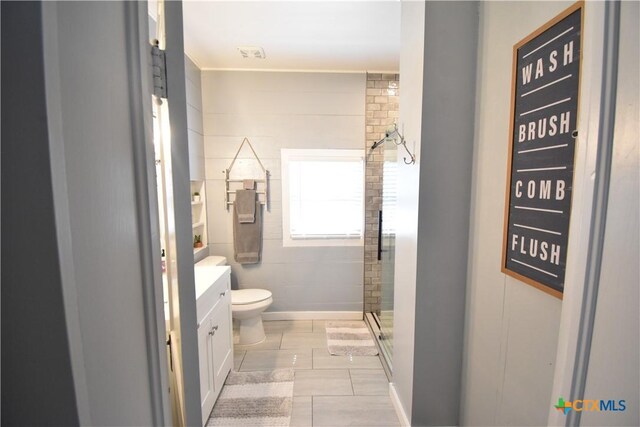 full bathroom featuring tile patterned floors, toilet, a stall shower, and vanity