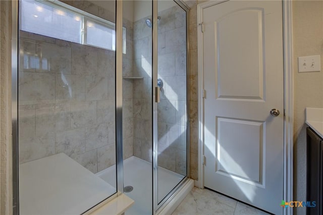 bathroom featuring vanity and a shower with door