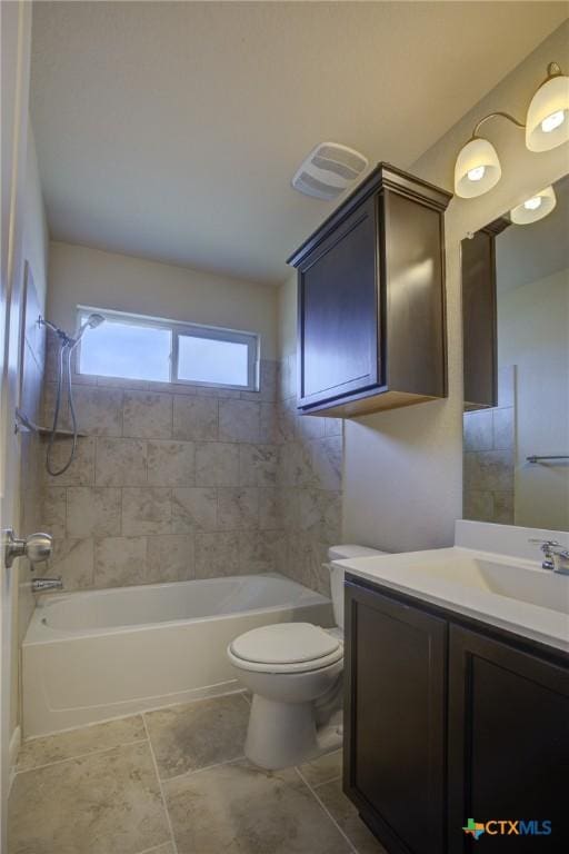 full bathroom with vanity, toilet, and tiled shower / bath combo