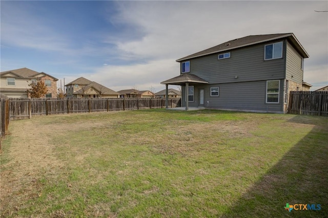 back of house with a yard