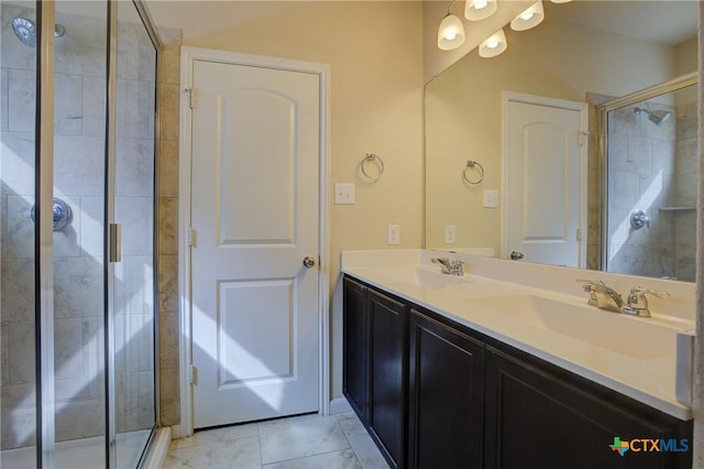 bathroom with a shower with door, vanity, and tile patterned flooring